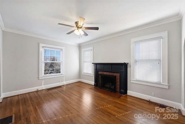 unfurnished living room with dark hardwood / wood-style flooring, a brick fireplace, ornamental molding, and ceiling fan