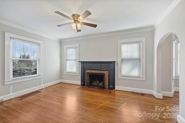 unfurnished living room featuring ornamental molding, a fireplace, and hardwood / wood-style floors