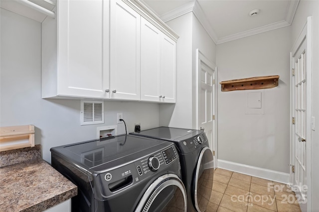 washroom featuring washer and clothes dryer, ornamental molding, cabinets, and light tile patterned flooring