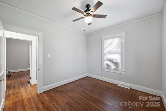 spare room featuring ceiling fan, ornamental molding, and dark hardwood / wood-style flooring