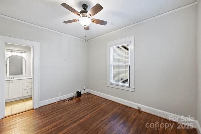 empty room with crown molding, ceiling fan, dark hardwood / wood-style flooring, and sink