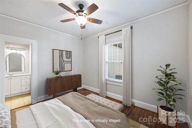 bedroom with dark hardwood / wood-style floors, sink, ceiling fan, crown molding, and ensuite bath