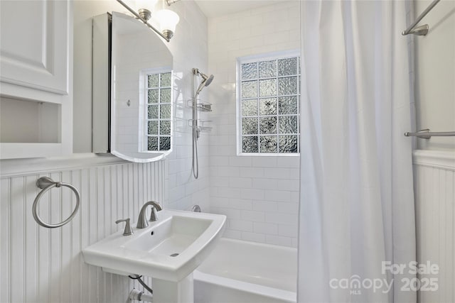 bathroom with shower / tub combo and sink