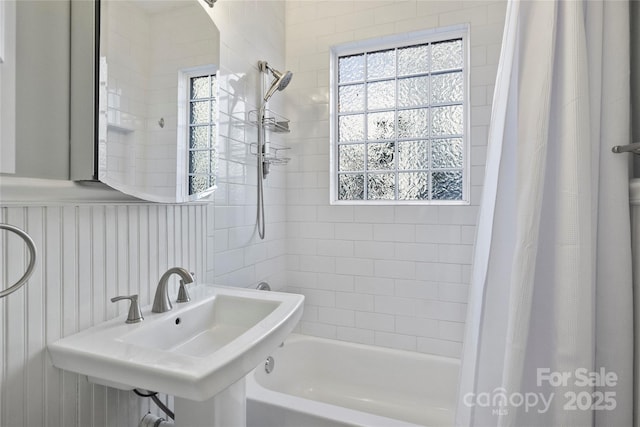 bathroom with sink and shower / bath combo with shower curtain