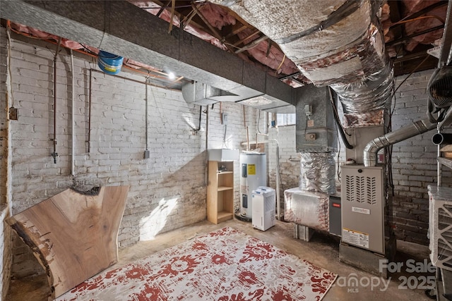 basement featuring brick wall and electric water heater