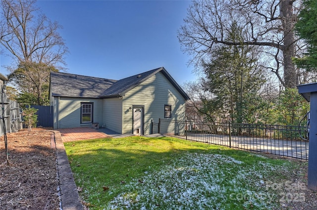 view of side of property with a yard and a patio area