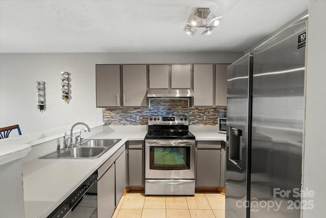 kitchen featuring appliances with stainless steel finishes, decorative backsplash, sink, gray cabinets, and light tile patterned flooring