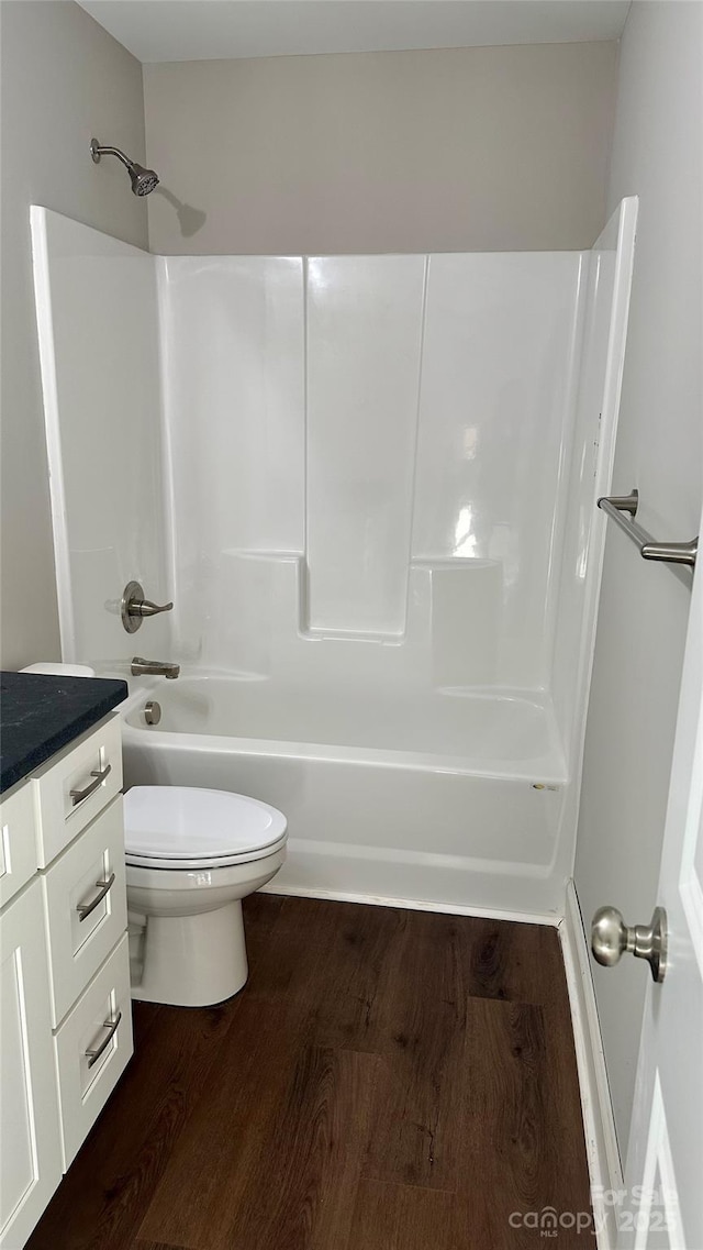 full bathroom featuring tub / shower combination, wood-type flooring, toilet, and vanity