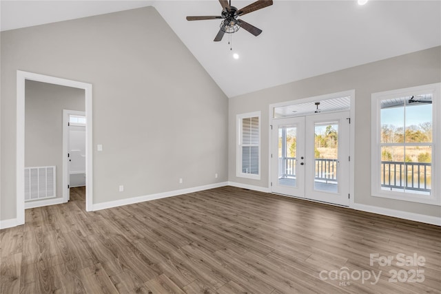 unfurnished living room featuring ceiling fan, light hardwood / wood-style flooring, french doors, and high vaulted ceiling