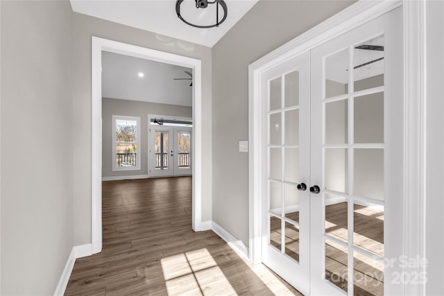 hall with french doors and hardwood / wood-style floors