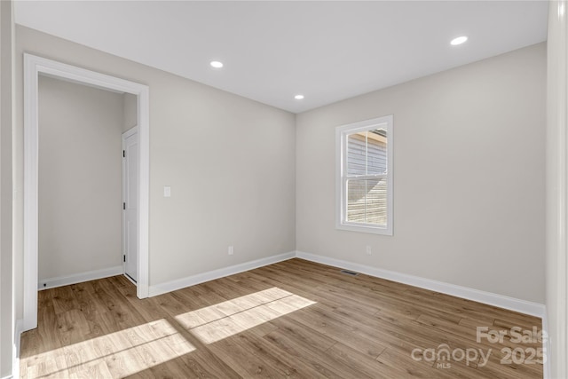 spare room with light hardwood / wood-style flooring