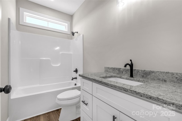 full bathroom featuring toilet, vanity, bathtub / shower combination, and hardwood / wood-style flooring