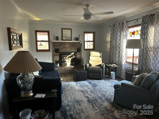 living room with ceiling fan, a healthy amount of sunlight, a fireplace, and crown molding