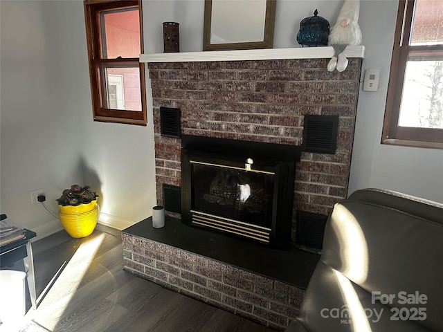 interior details with a brick fireplace and hardwood / wood-style floors