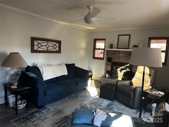 living room with ceiling fan, a brick fireplace, a wealth of natural light, and crown molding