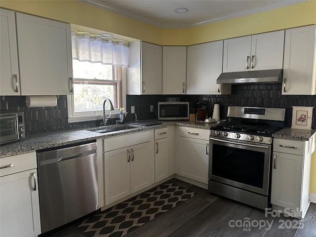 kitchen featuring stainless steel appliances, white cabinetry, and sink