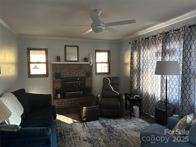 carpeted living room featuring ceiling fan, ornamental molding, and a fireplace