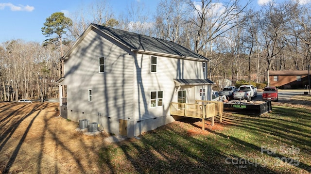 view of side of property with a wooden deck, cooling unit, and a lawn