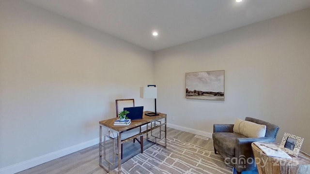 home office with wood-type flooring