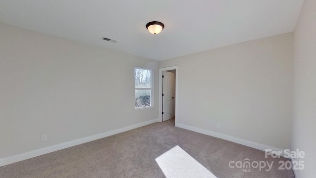 unfurnished room with light colored carpet