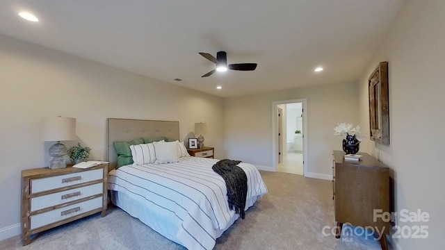 bedroom featuring ceiling fan, ensuite bath, and light carpet