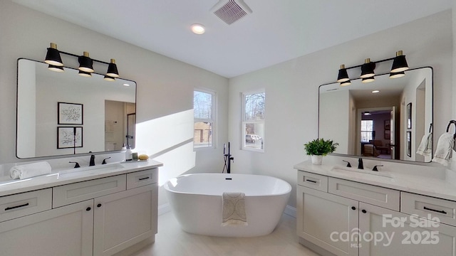 bathroom with vanity and a tub