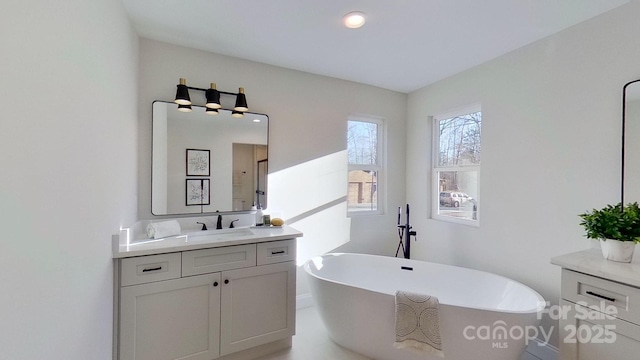 bathroom with vanity and a tub