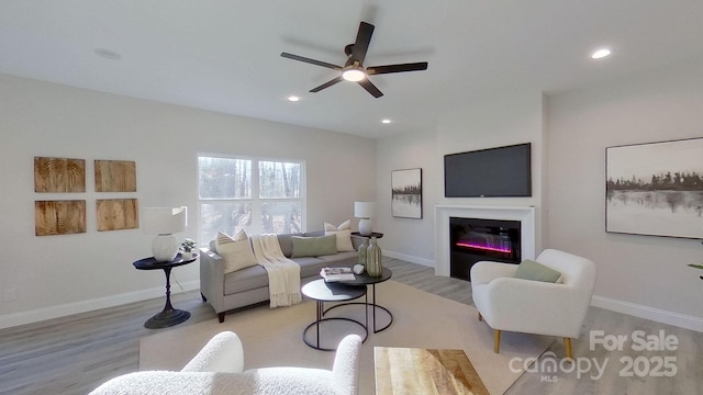 living room with ceiling fan and light wood-type flooring