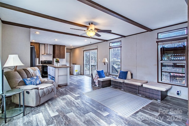 living room with ceiling fan, washer / dryer, beam ceiling, crown molding, and dark hardwood / wood-style flooring