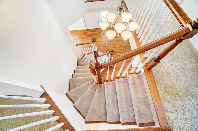 stairway featuring a chandelier