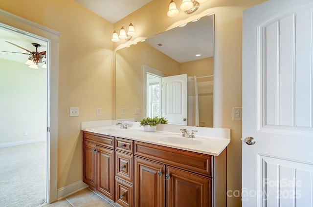 full bath with tile patterned flooring, a sink, visible vents, baseboards, and double vanity