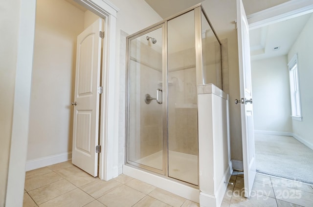 full bath featuring baseboards, a shower stall, and tile patterned floors