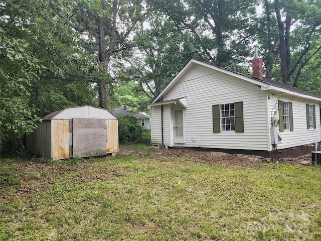 view of property exterior with a storage shed and a yard