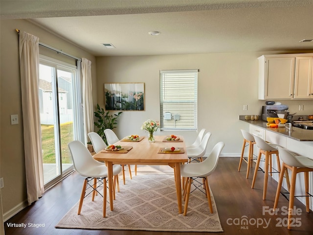 dining area featuring dark hardwood / wood-style flooring