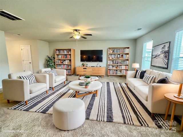 living room featuring carpet floors and ceiling fan