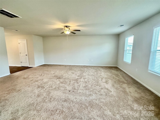 carpeted empty room featuring ceiling fan