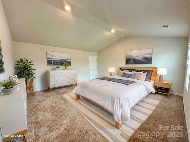 carpeted bedroom with vaulted ceiling