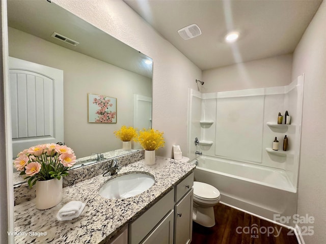 full bathroom with wood-type flooring, shower / bath combination, toilet, and vanity