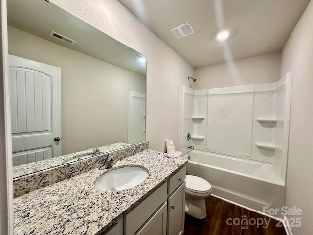 full bathroom with washtub / shower combination, hardwood / wood-style flooring, toilet, and vanity