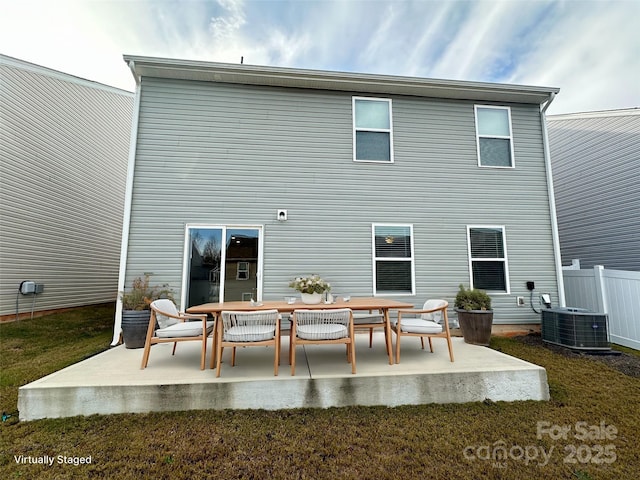 rear view of house featuring central air condition unit and a patio