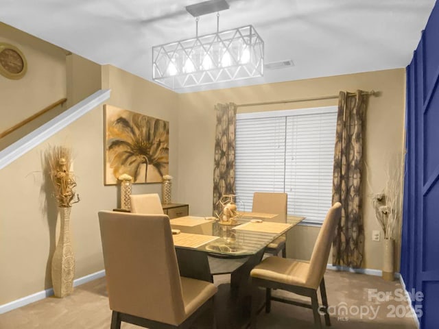 dining room featuring light carpet