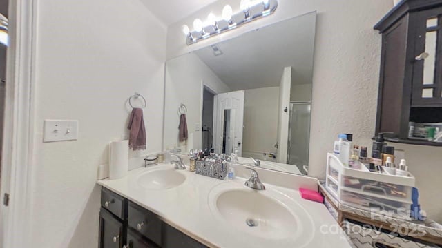 bathroom with an enclosed shower, vanity, and toilet