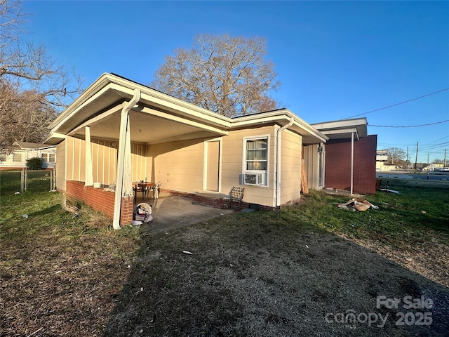 view of property exterior with a lawn and a carport