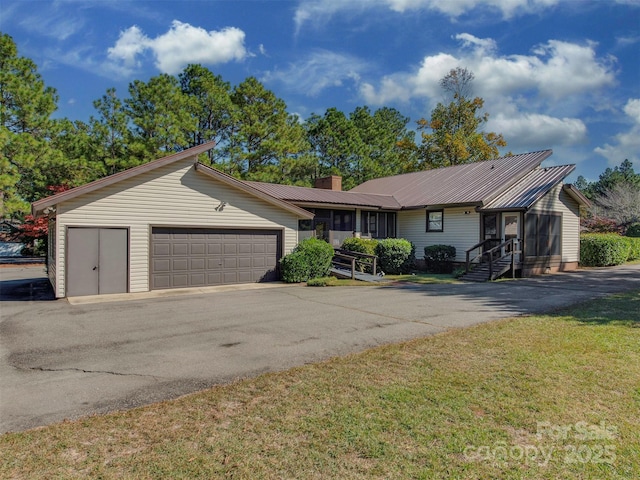 single story home with a front yard and a garage