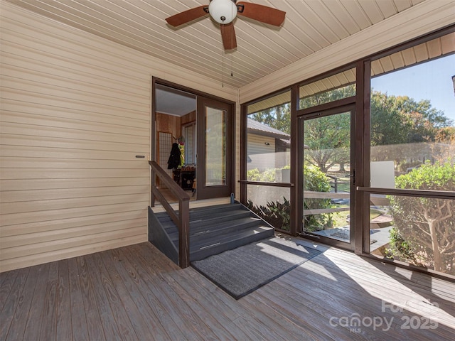 unfurnished sunroom with ceiling fan