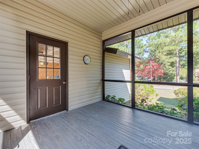 unfurnished sunroom with wooden ceiling