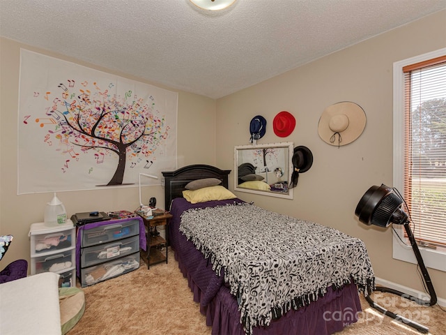 carpeted bedroom featuring a textured ceiling