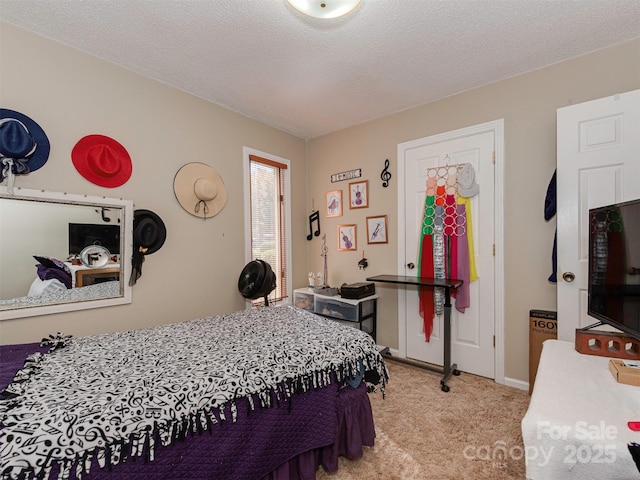 bedroom with a textured ceiling and light carpet