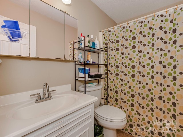 bathroom featuring curtained shower, a textured ceiling, toilet, and vanity