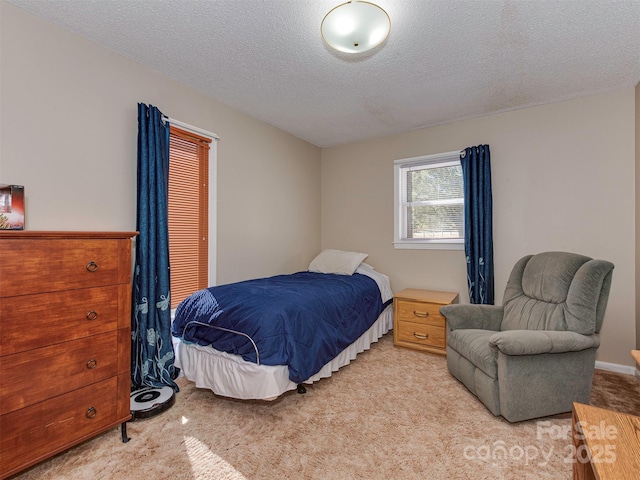 carpeted bedroom with a textured ceiling